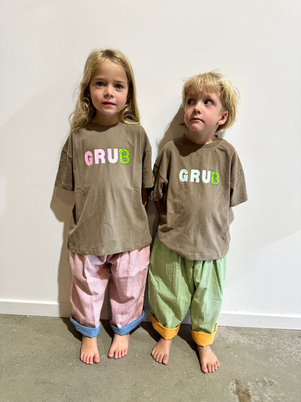 Brown coloured cotton kids tee with blue “grub” text