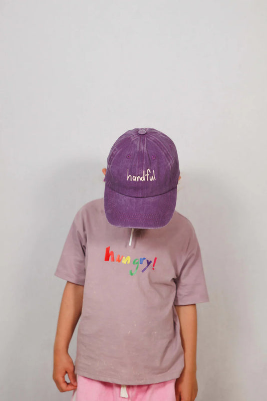 Purple cotton cap with “handful” text in white