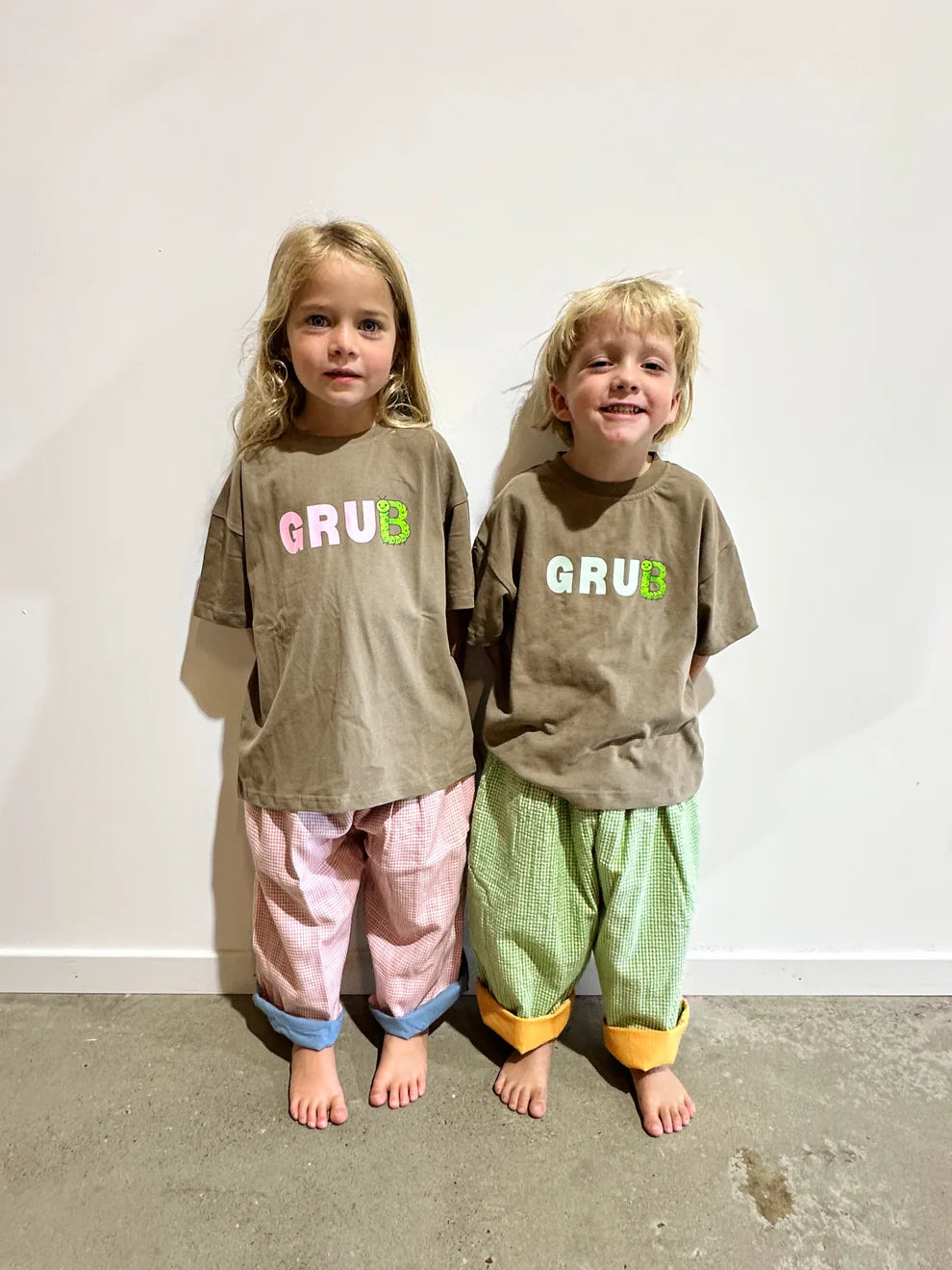Brown coloured cotton kids tee with blue “grub” text