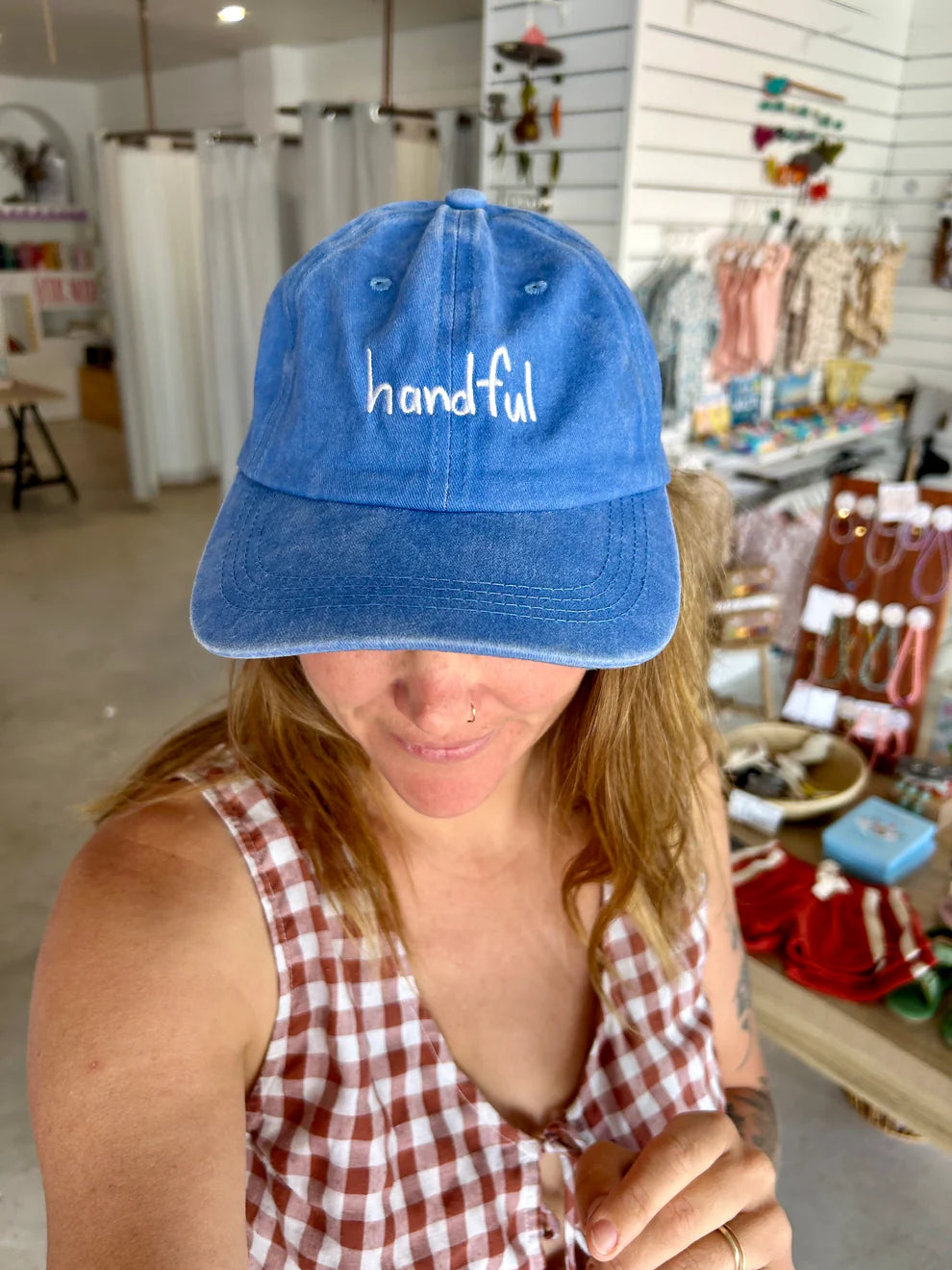 Blue cap with white “handful” text made from cotton