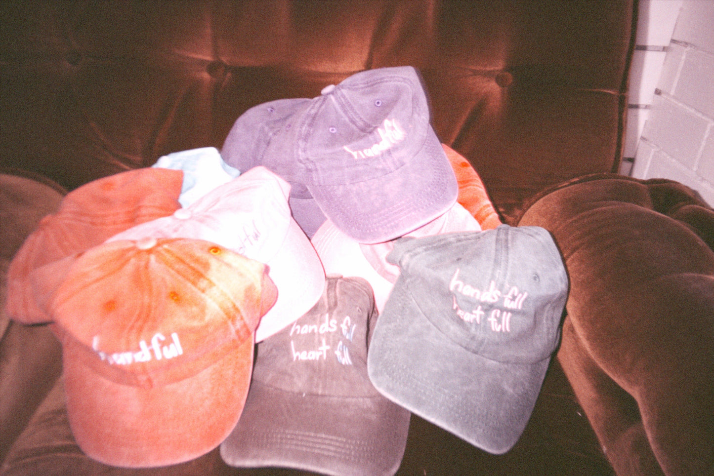 Mixed coloured caps with  “handful” or “hands full heart full” text made from cotton
