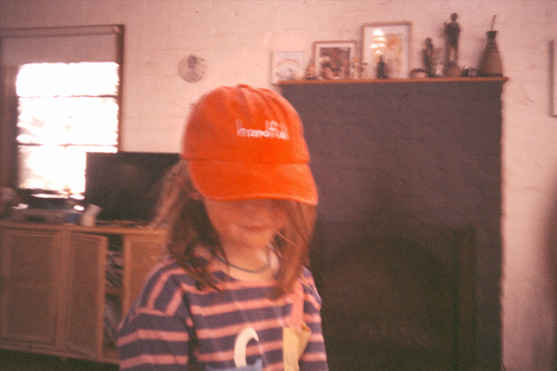 Red coloured cotton cap with “handful” text in blue