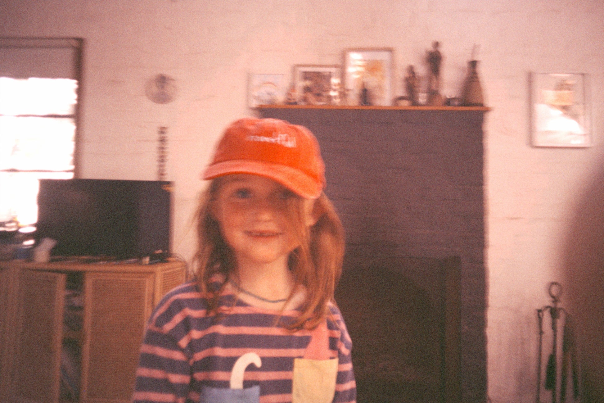 Red coloured cotton cap with “handful” text in blue