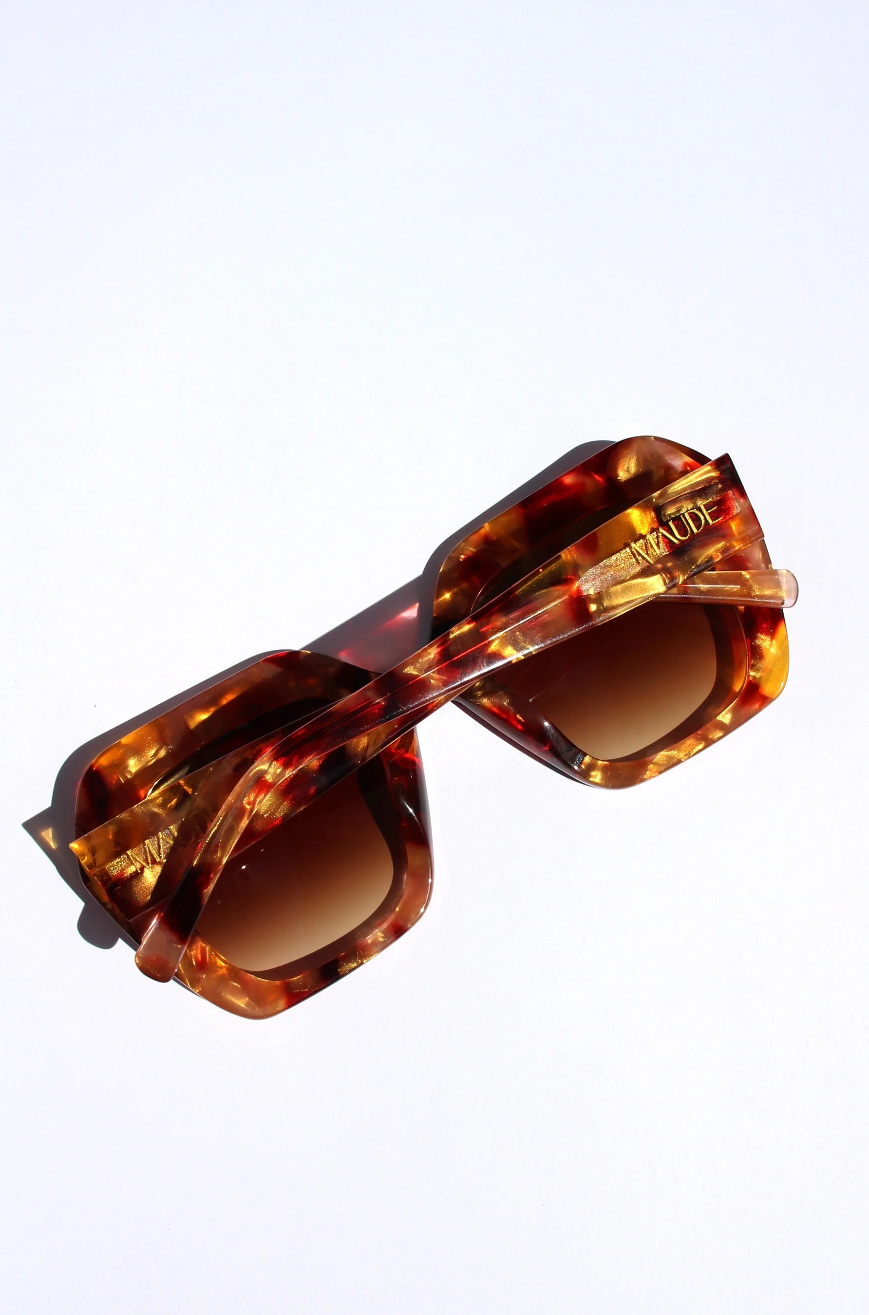 Oversized oval sunglasses in red and apricot tort with crystals