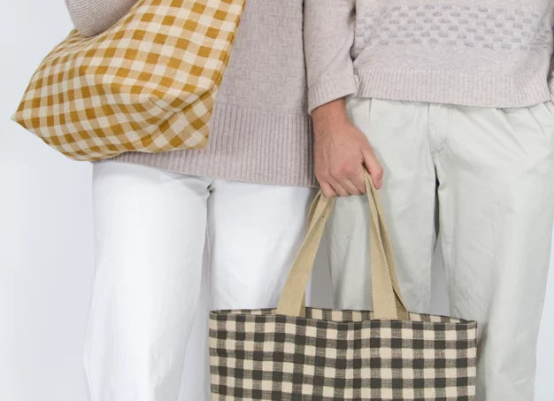 Ochre and Cream & Navy and Cream Gingham Tote bags being held